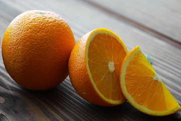 Orange citrus fruit on a stone table. Orange background.