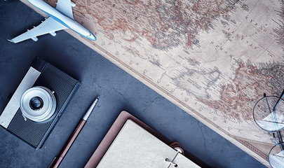Travel concept. Map on the table andl aircraft.
