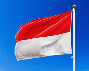 Indonesian flag on the blue sky. Isolated with clipping path. 