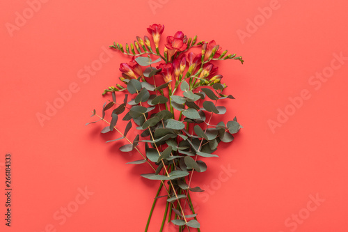 Happy Mother's Day, Women's Day, Valentine's Day or Birthday Living Coral Pantone Color Background. Coral flat lay greeting card with beautiful flowers.