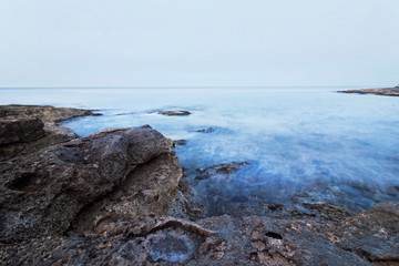 long exposure of peaceful blue ocean at coast 