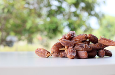 Dried date on wooden table close up