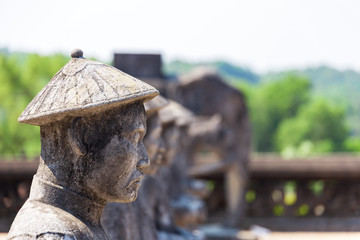 stone statues of soldiers with weapons and in full armor