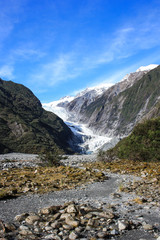 Fototapeta na wymiar View on the Franz Josef Glacier, rocky climb with some green vegetation on both sides, West Coast of New Zealand's South Island