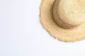 Fototapeta na wymiar Pretty straw hat on white background. Space for text, top view
