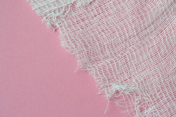 Medical bandage on a pink background close-up.