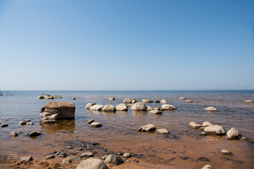 Fototapeta na wymiar Stones balance on the beach. Place on Latvian coasts called Veczemju klintis