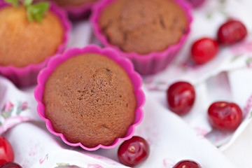 Chocolate muffins with ripe cherries