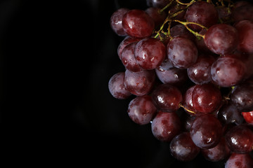 Grapes on a black background close-up, selective focus. Delicious and diet food