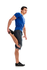 Full photo of young man stretching his legs before training