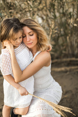 Fototapeta premium mother and daughter hugging in nature at summer