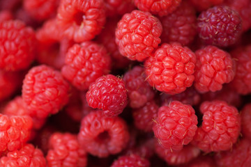 Ripe juicy raspberries on wooden background