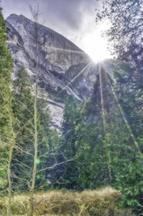 Half Dome and the sun breaking through the clouds