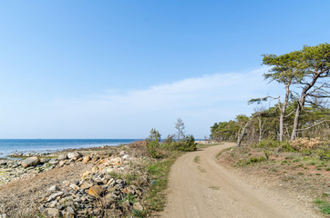 Beautiful winding gravel road by the coast