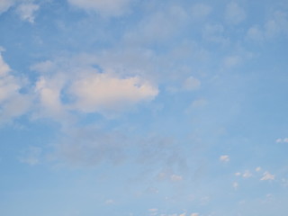 Ant't eye view of many white clouds moving with blue sky background.