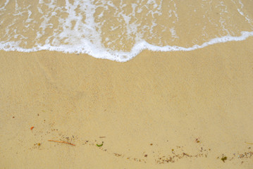 Soft wave of blue ocean on sandy beach. Background