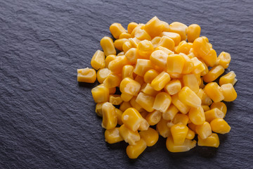 canned corn on a dark stone background