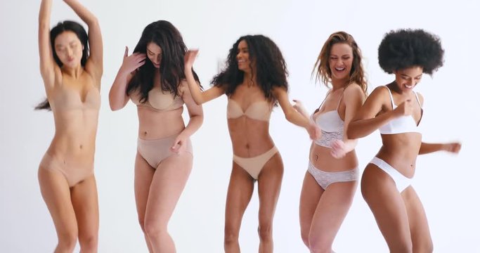 Group of multi ethnic women with different kind of beauty and body, posing and having fun in a studio