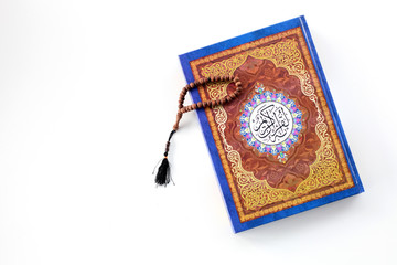 Ramadan kereem with holy quran, dates and rosary isolated on white background