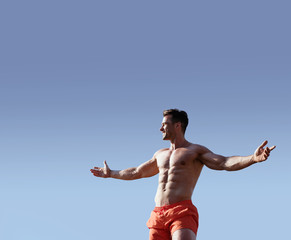 Obraz premium Portrait of a handsome, muscular man wearing red trunks