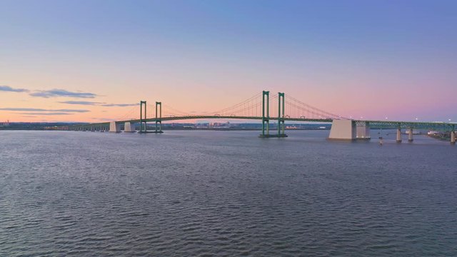 Aerial drone shot of Delaware Memorial Bridge at dusk. The Delaware Memorial Bridge is a set of twin suspension bridges crossing the Delaware River between the states of Delaware and New Jersey