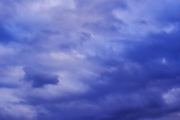 The sky in the clouds with the light of the sunset. The texture of the clouds, the background image.