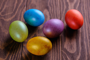 Easter cakes and colored eggs on a wooden table