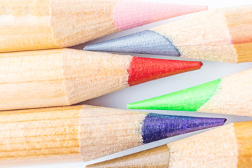 Sharpened art color pencils close up on a white background. Macro photography, flat lay.