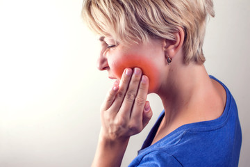 Woman feels strong tooth pain. People, healthcare and medicine concept