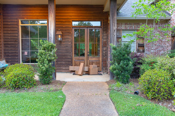 Shipping Packages on front porch of house, in front of the door.