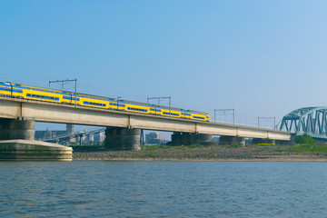 Dutch passenger train passing a bridge