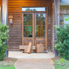 Shipping Packages on front porch of house, in front of the door.