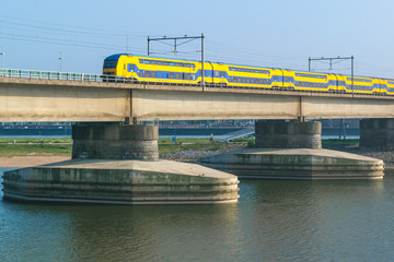 Dutch passenger train passing a bridge