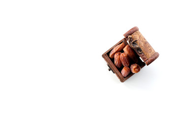 ramadan concept. dry dates in a wooden box isolated on white background