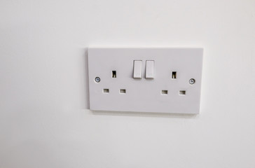 Double electric plug socket with two switches to turn on and off.