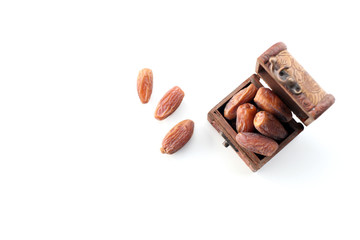 ramadan concept. dry dates in a wooden box isolated on white background