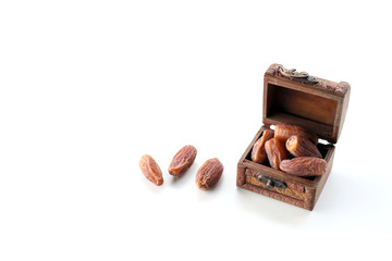 ramadan concept. dry dates in a wooden box isolated on white background