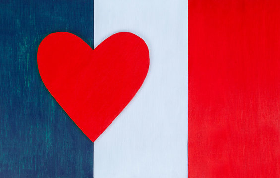 French flag and heart, love for France, Paris & French culture - painted wooden background for rustic, vintage and authentic styles - tricolor of the nation of France.