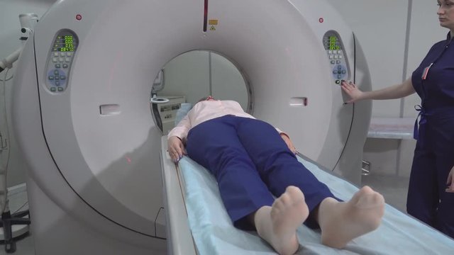 A scanning room with computers and monitors next to the CT scan room in a new modern cancer treatment hospital. 4k