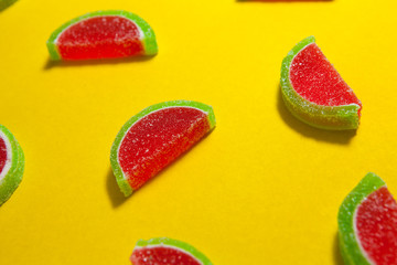 Fruit jelly segments in the form of watermelon on yellow