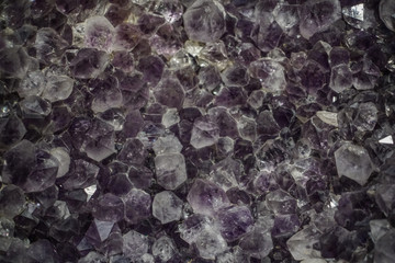 Raw cluster rough crystals close up in low light background