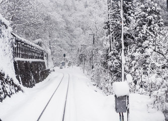 Snowstorm with and poor visibility on the railroad tracks. Winter season in Toyama city, Japan.