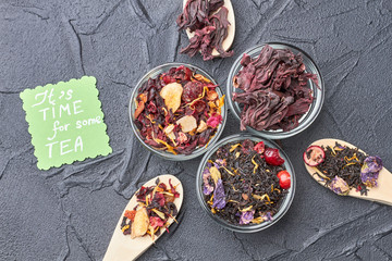 Flat lay composition with different types of dry tea leaves. Assorted teas in glass bowls. It's time for some tea.