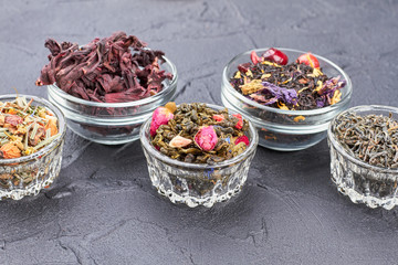 Group of glass bowls with assorted dried teas. Chinese tea culture.