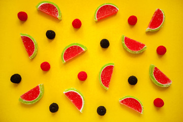 Fruit jelly segments in the form of watermelon on yellow