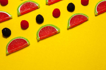 Fruit jelly segments in the form of watermelon on yellow