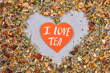 I love tea concept. Heart made of dried herbal tea close up.
