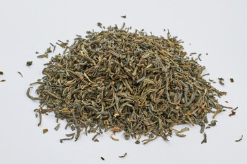 Close up heap of dried green tea leaves. Dry green tea leaves on white background.