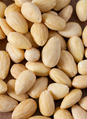 peeled almonds on wooden surface