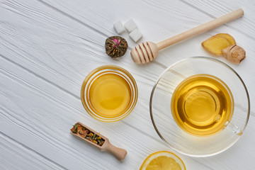 Cup of tea with lemon and ginger on wooden table. Healthy drink for cold winter.